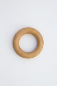 A round doughnut shaped object handmade from American Oak for styling coffee tables.