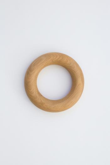 A round doughnut shaped object handmade from American Oak for styling coffee tables.