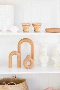 A white shelf is styled with some of the objects that are for sale in the Wholehearted Studio.