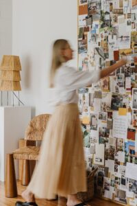 Wholehearted Studio team member places and photo to the Studio Pinboard.