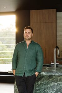 Builder standing in him newly completed kitchen in Brisbane.
